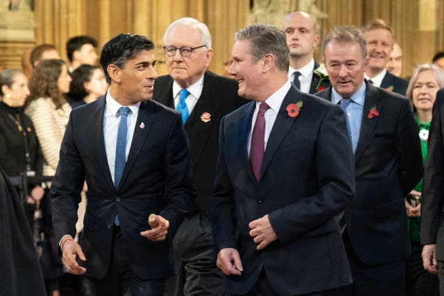 <p>Rishi Sunak and Keir Starmer walk through the Central Lobby at the Palace of Westminster before the King’s Speech on Tuesday</p>